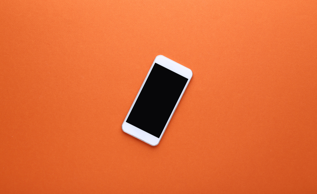 IPhone against an orange background.