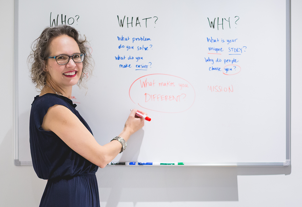 Lidia speaking in front of whiteboard 