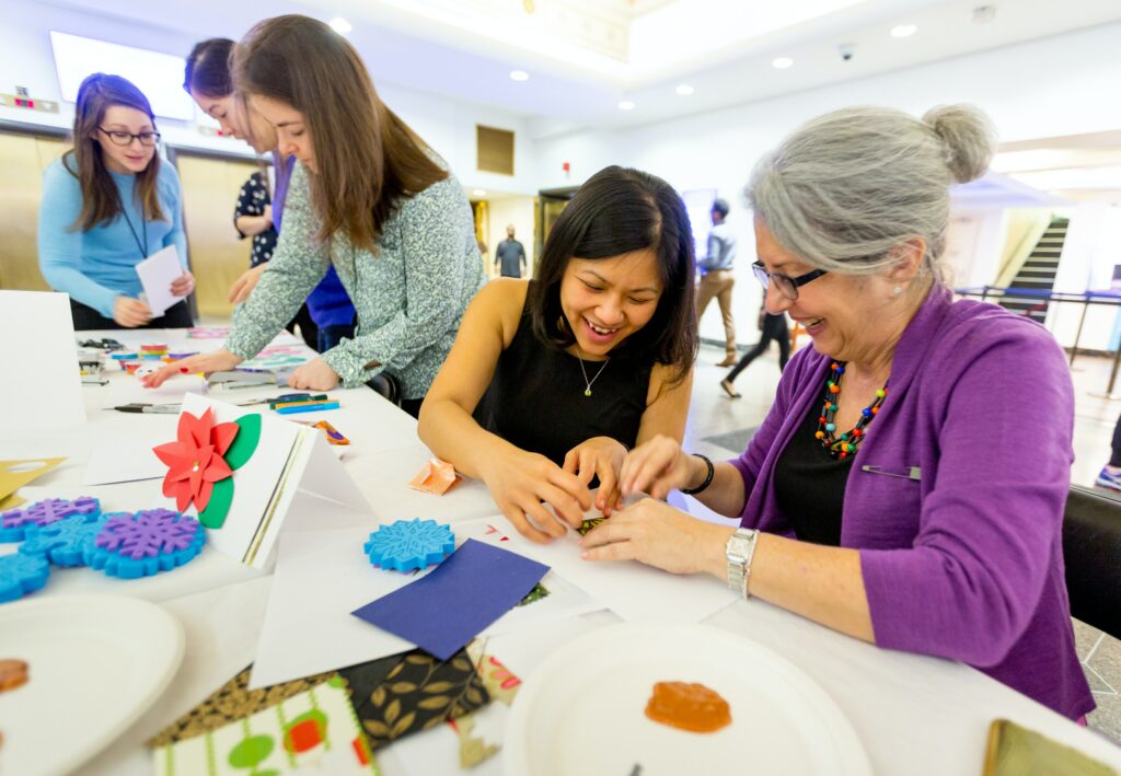 Group of various ages making crafts together 